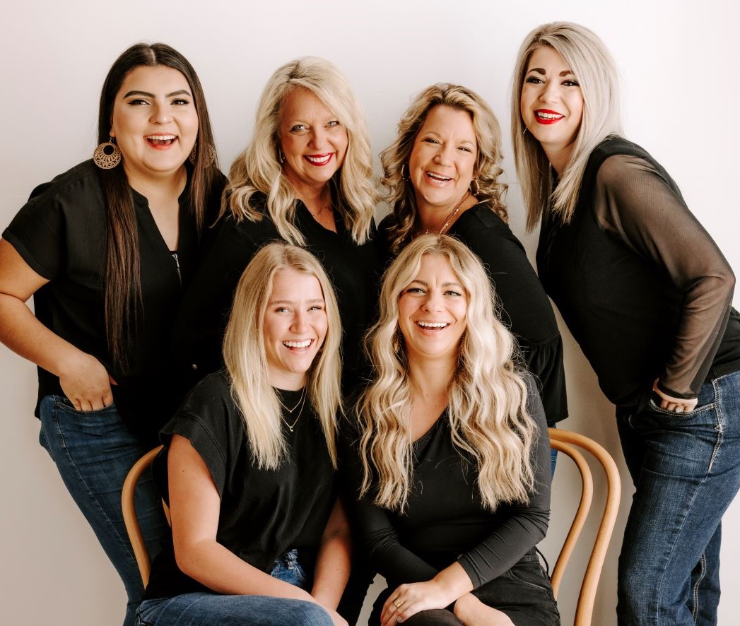 Six smiling women in photography studio
