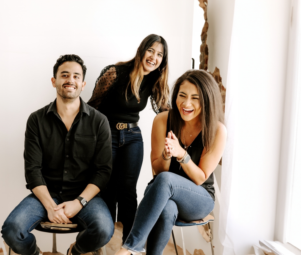 Man and two women smiling in photography studio