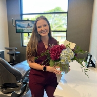 Waco dental team member holding flower bouquet