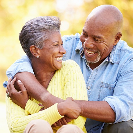 older couple smiling and hugging