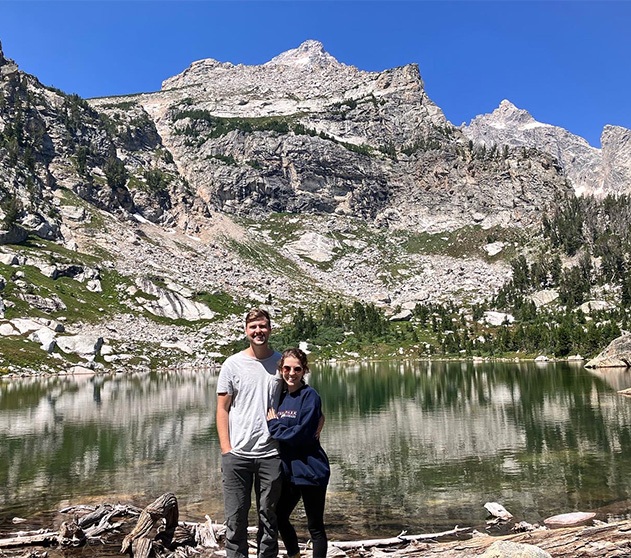 Dr. Ethan and wife in front of snow covered mountains