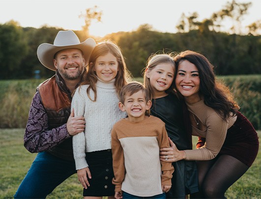 Doctor Lassetter smiling with her husband and three children