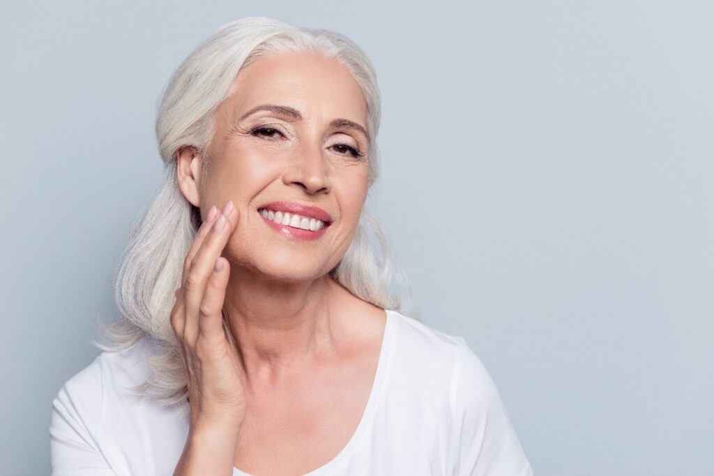 smiling older person wearing dentures